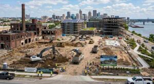 Brownfield redevelopment site with demolition, excavation and new mixed-use construction along urban riverfront