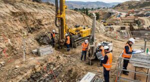 Geotechnical drilling team performing soil core sampling at highway infrastructure project