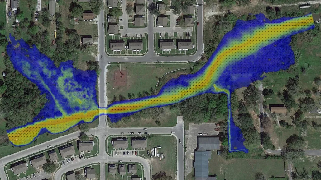 Two-dimensional HEC-RAS flow model of Bayou Auguste in Biloxi, Mississippi, overlaid on an aerial, showing flow velocity and direction along the restored stream corridor through the surrounding neighborhood