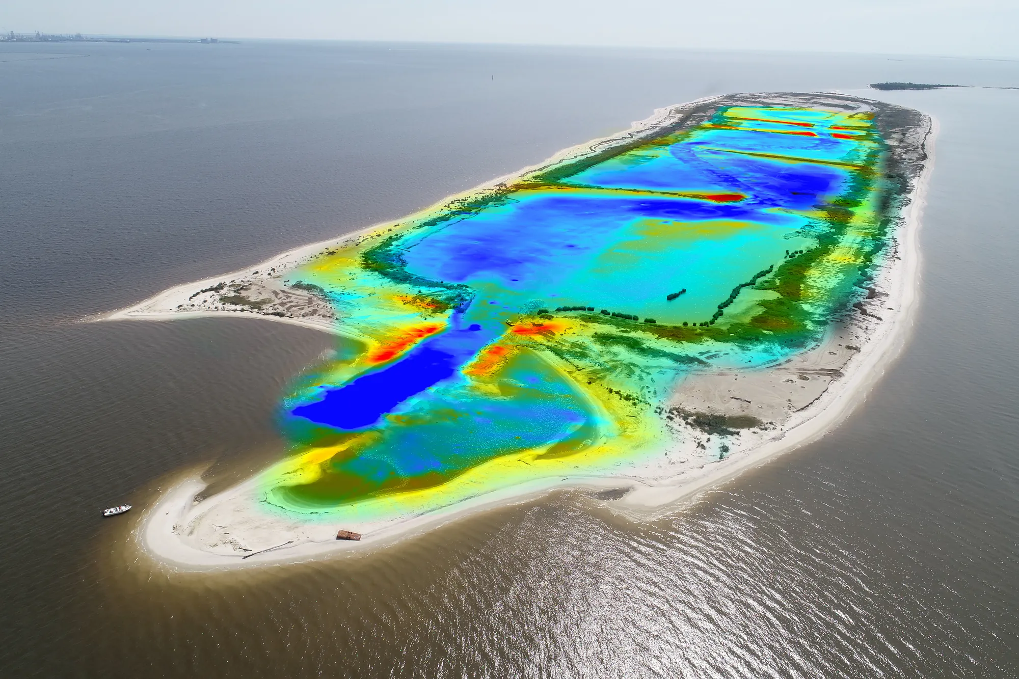 Oblique aerial of Round Island, Mississippi, with a combined topographic and bathymetric elevation model overlaid to show the as-built dredged channels and marsh basins